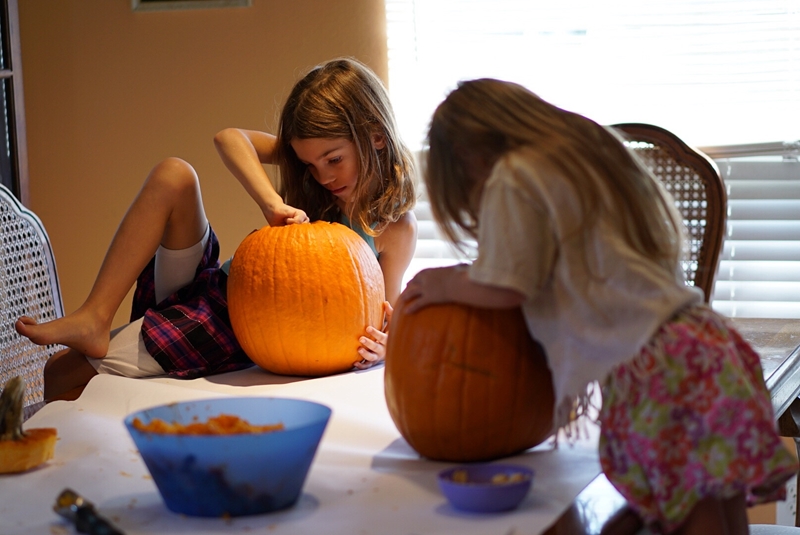 Pumpkin carving is a Halloween party idea for kids that's fun, not scary
